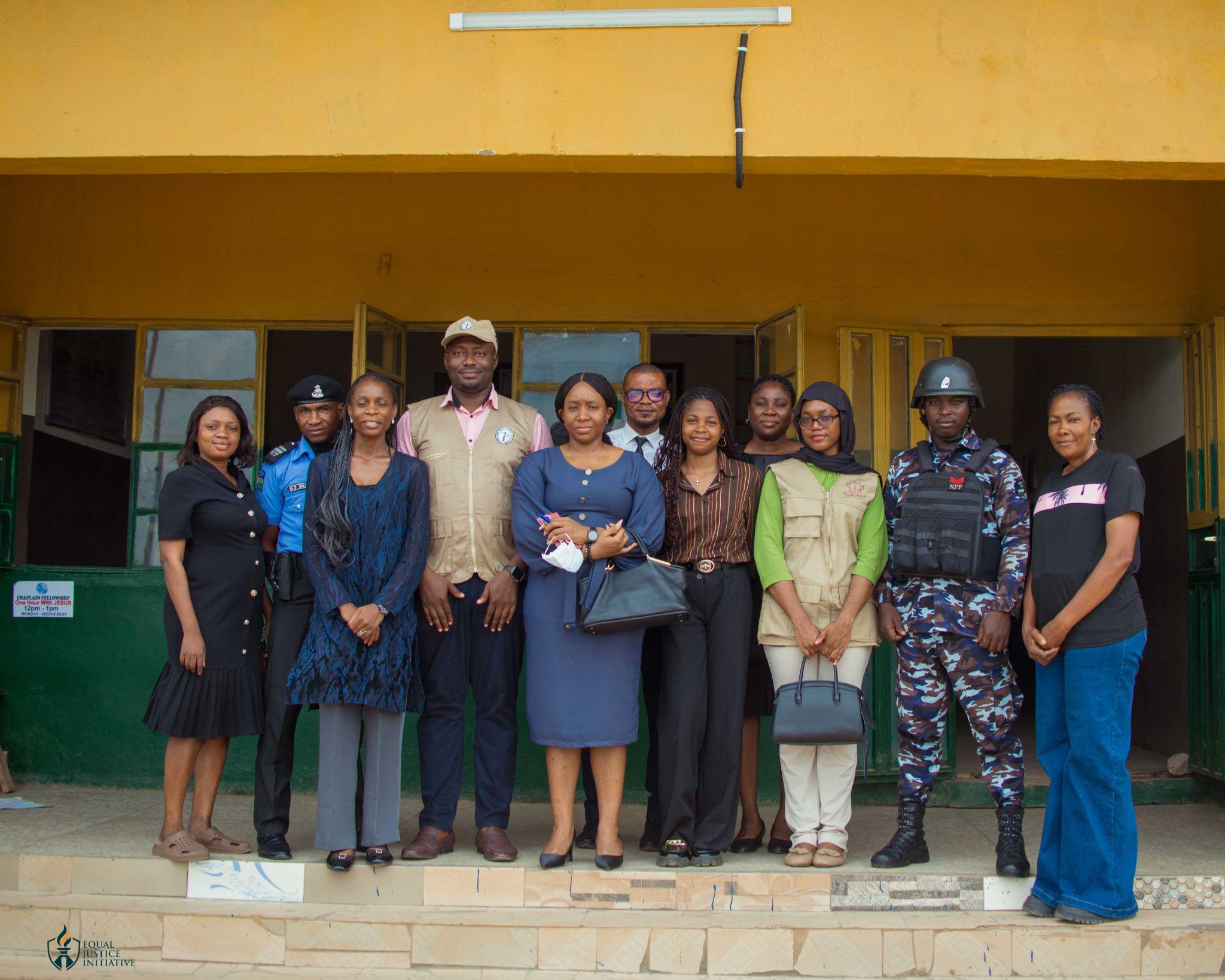 Oversight team and police officers at the entrance of Bwari Police Division, Abuja